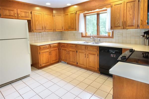 64 Cedar Street Walpole, MA 02081 - Photo 3 of 28 a kitchen with a sink a stove and cabinets