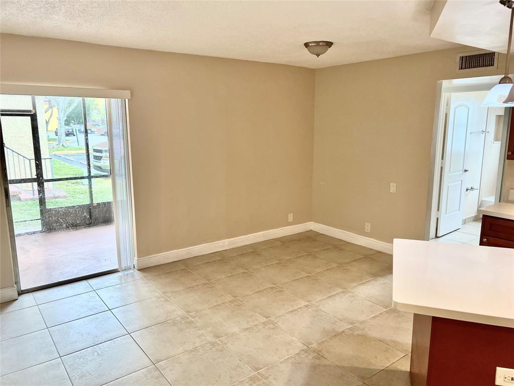 4425 Treehouse Lane, Unit A Tamarac, FL 33319 - Photo 2 of 9 a view of a kitchen with an empty space