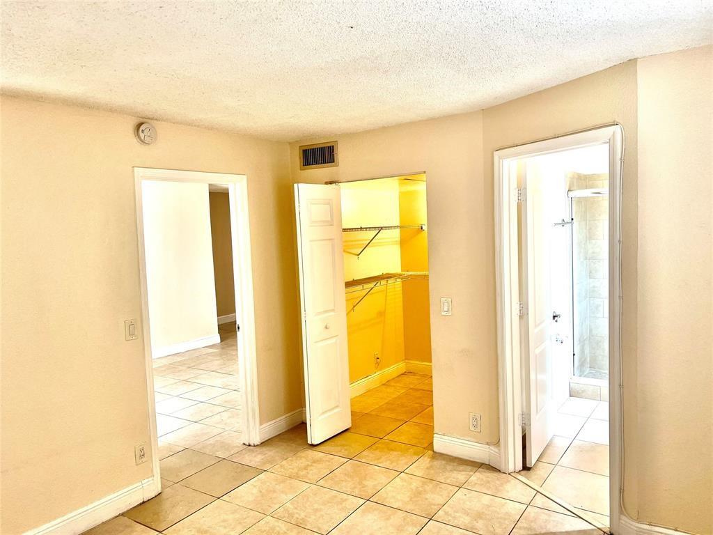 4425 Treehouse Lane, Unit A Tamarac, FL 33319 - Photo 6 of 9 a view of a bathroom with a shower