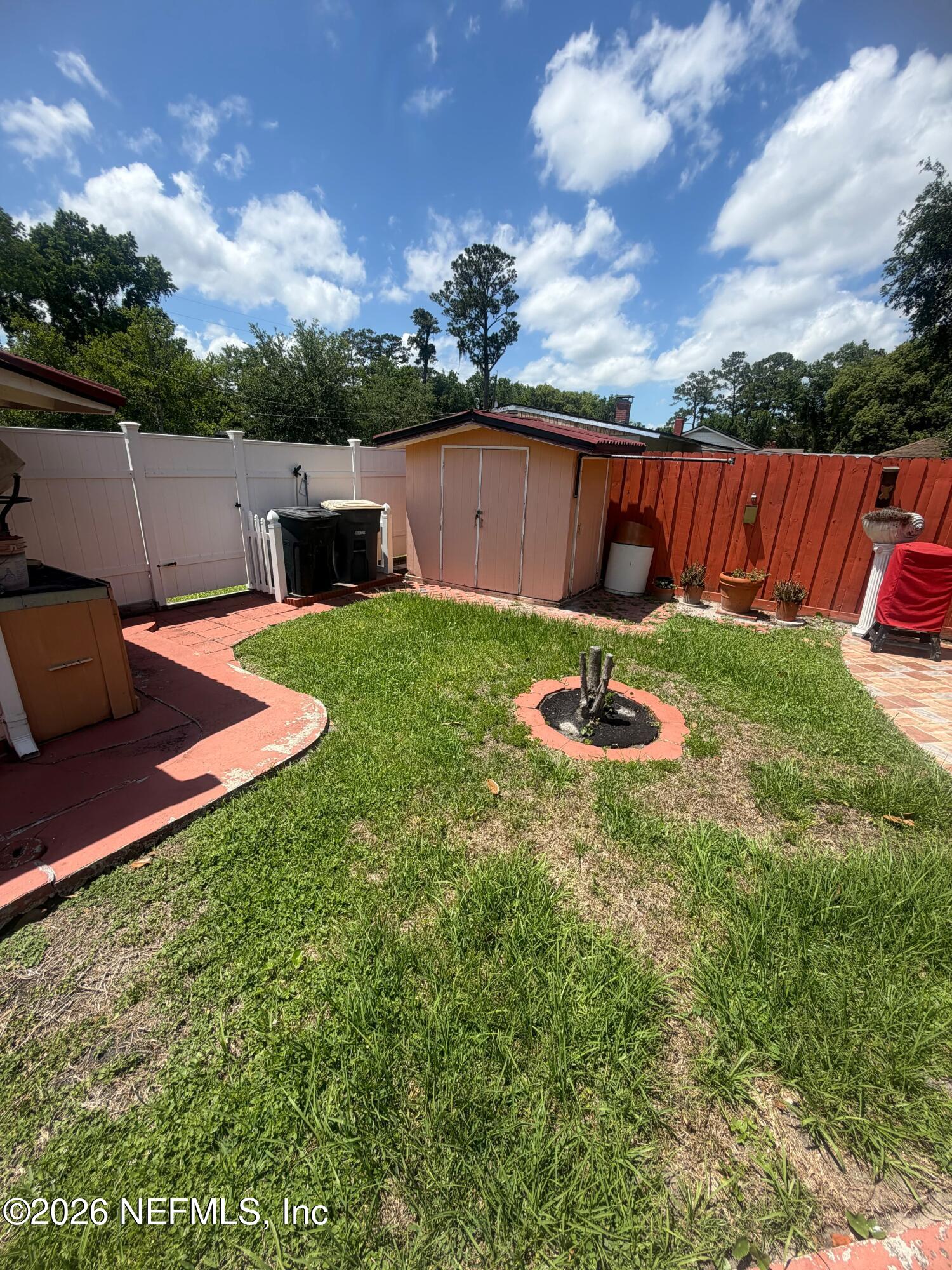 4127 Springwood Road Jacksonville, FL 32207 - Photo 51 of 63 a backyard of a house with table and chairs
