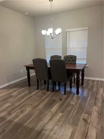 a view of a dining room with furniture and chandelier