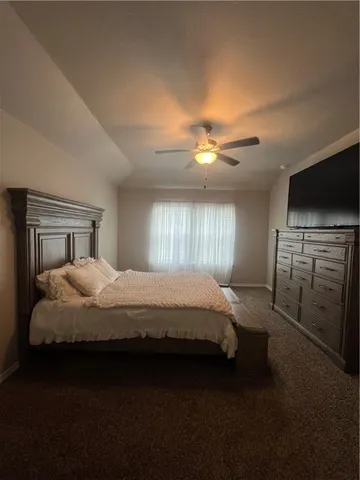 a bedroom with a bed and a tv