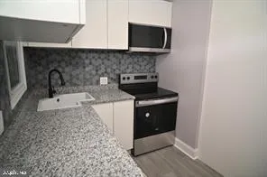 a kitchen with a sink and a microwave
