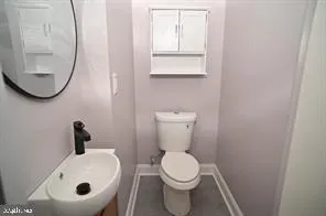 a bathroom with a toilet and a sink
