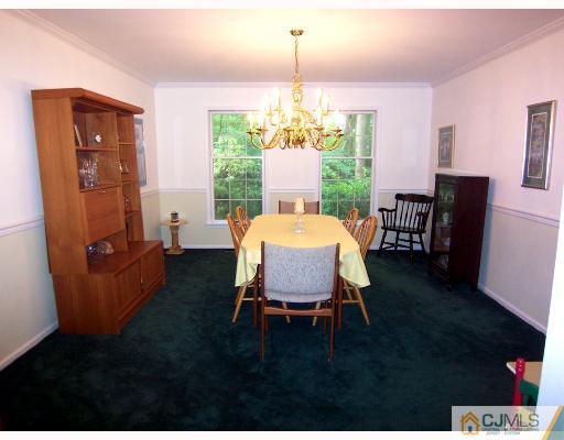 3 Fox Hill Road Edison, NJ 08820 - Photo 3 of 10 a dining room with furniture a chandelier and window