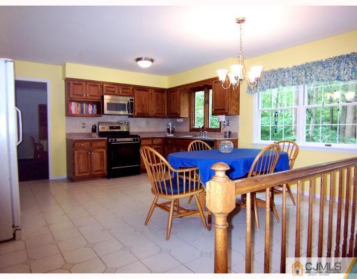 3 Fox Hill Road Edison, NJ 08820 - Photo 4 of 10 a view of a dining room and livingroom with furniture wooden floor a chandelier