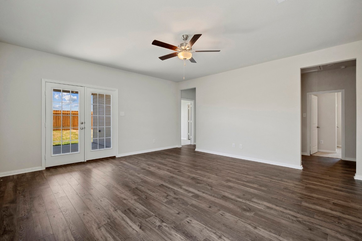 10403 Red Cardinal Drive Cleveland, TX 77328 - Photo 10 of 24 a view of an empty room with wooden floor and a window