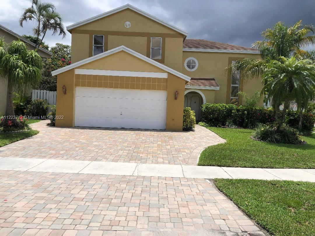 River Run Miramar, FL 33025 - Photo 1 of 23 a front view of a house with a yard and garage