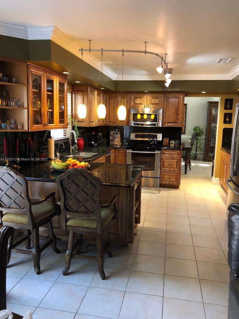 River Run Miramar, FL 33025 - Photo 11 of 23 a view of a patio with dining table and chairs