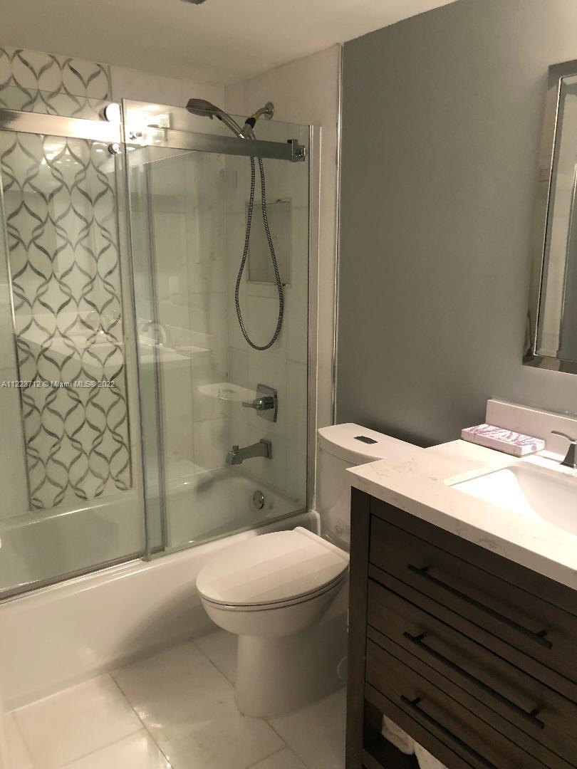 River Run Miramar, FL 33025 - Photo 17 of 23 a bathroom with a granite countertop bathtub shower and a toilet