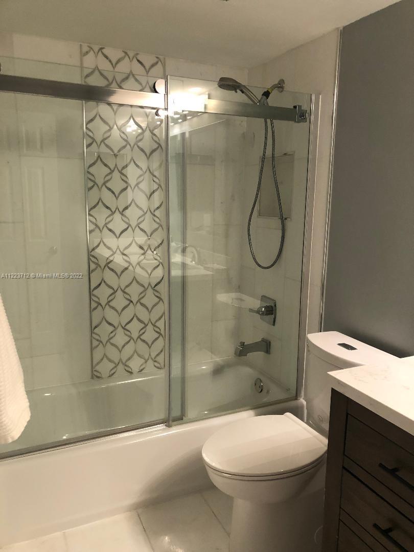 River Run Miramar, FL 33025 - Photo 18 of 23 a bathroom with a shower a toilet and sink