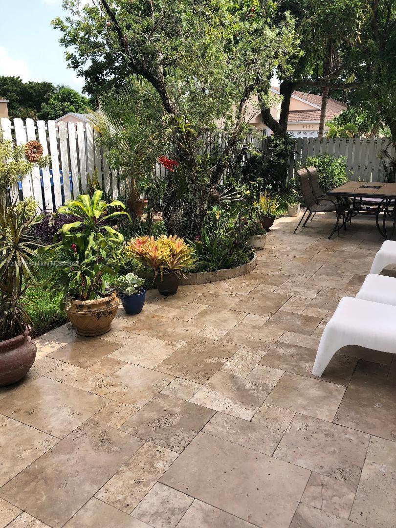 River Run Miramar, FL 33025 - Photo 22 of 23 a view of a garden with chairs and a potted plant