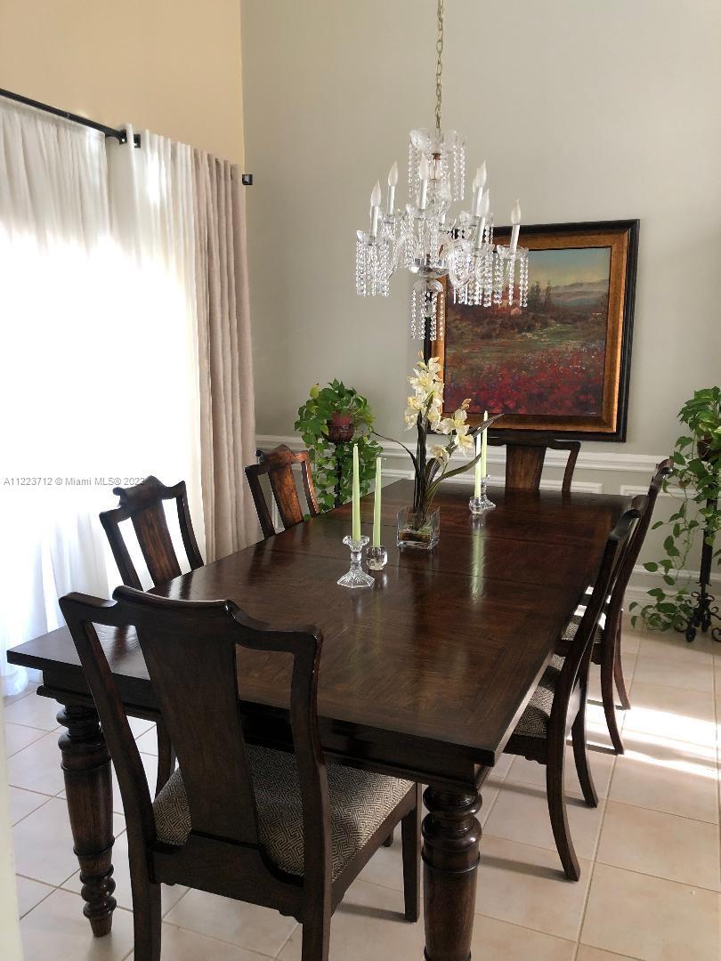 River Run Miramar, FL 33025 - Photo 8 of 23 a view of a dining room with furniture and chandelier