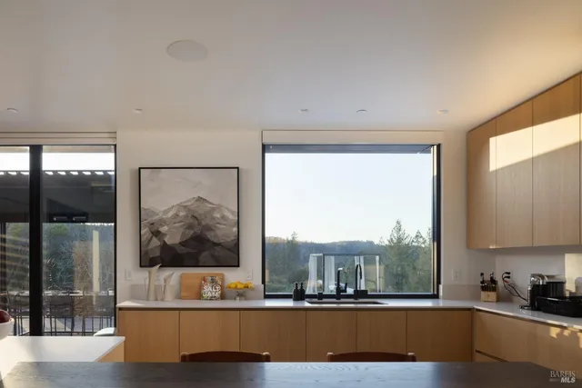 a living room with a large window and a wooden floor