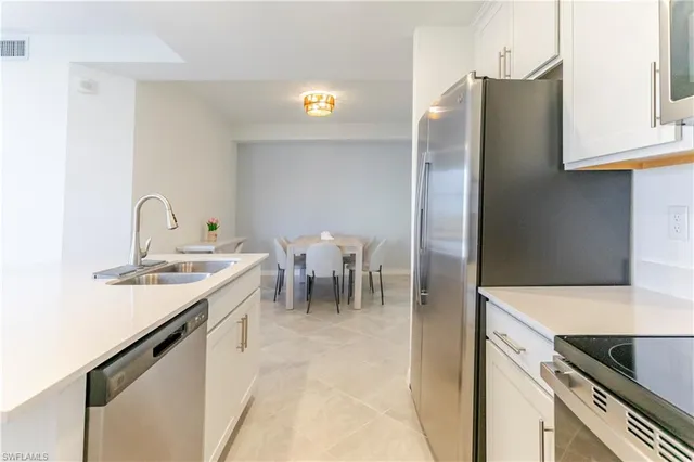 a kitchen with a sink and a refrigerator