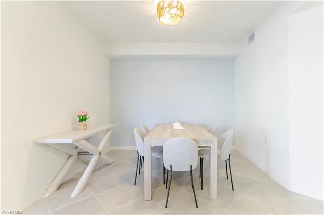 a view of a dining room with furniture and a window