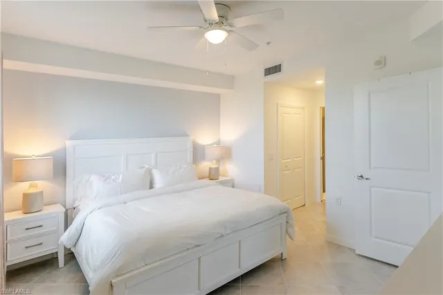 a bedroom with a bed and a lamp