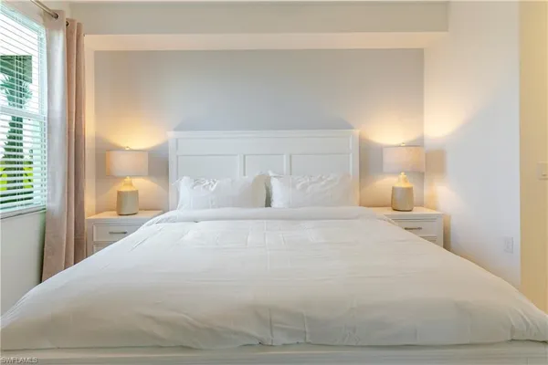 a large white bed in a white room