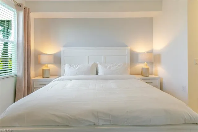 a large white bed in a white room