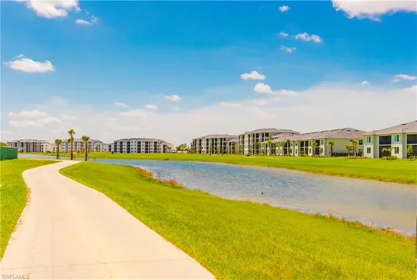 a view of a swimming pool with furniture