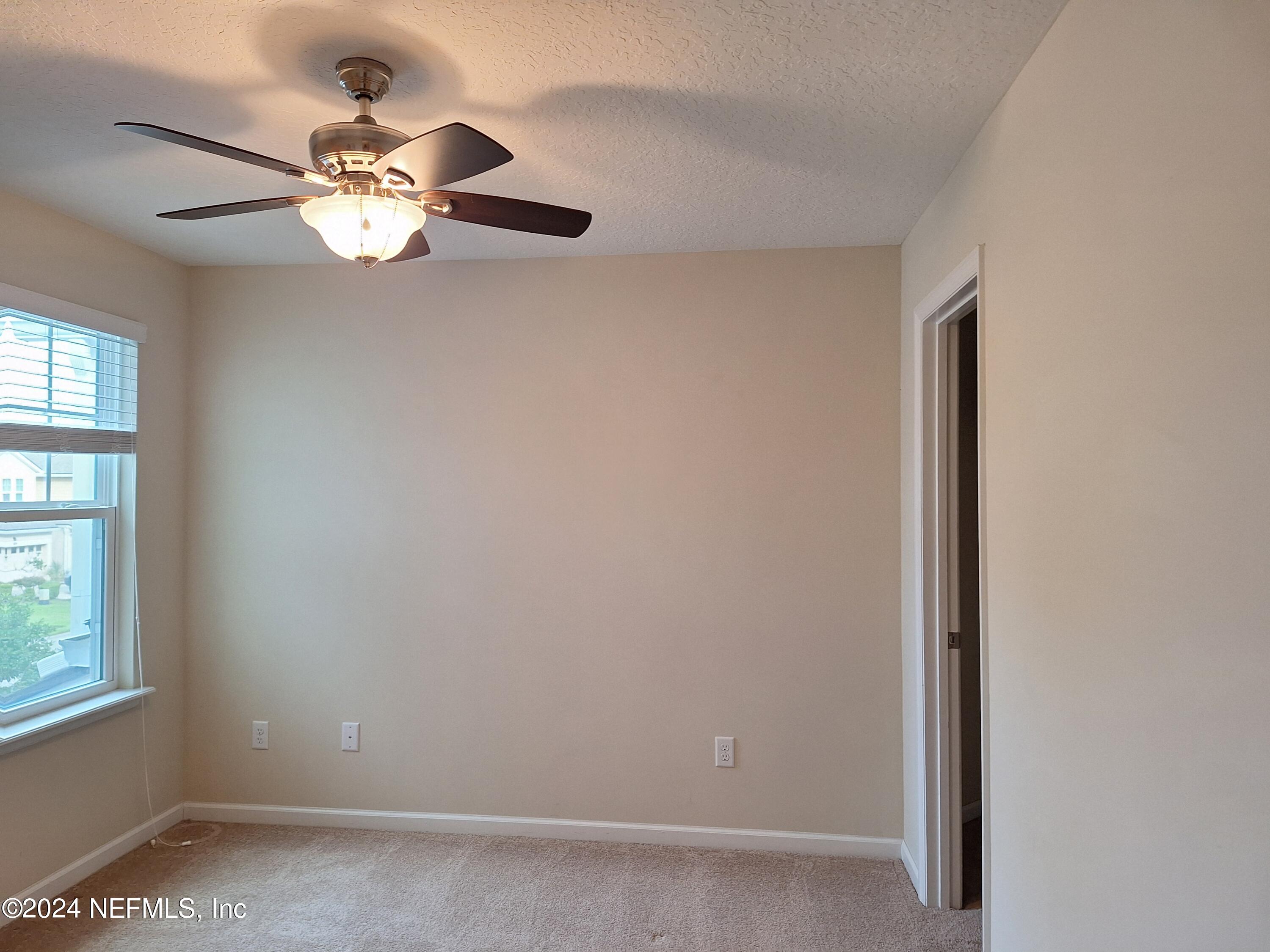 177 Richmond Drive St. Johns, FL 32259 - Photo 13 of 29 an empty room with windows and fan