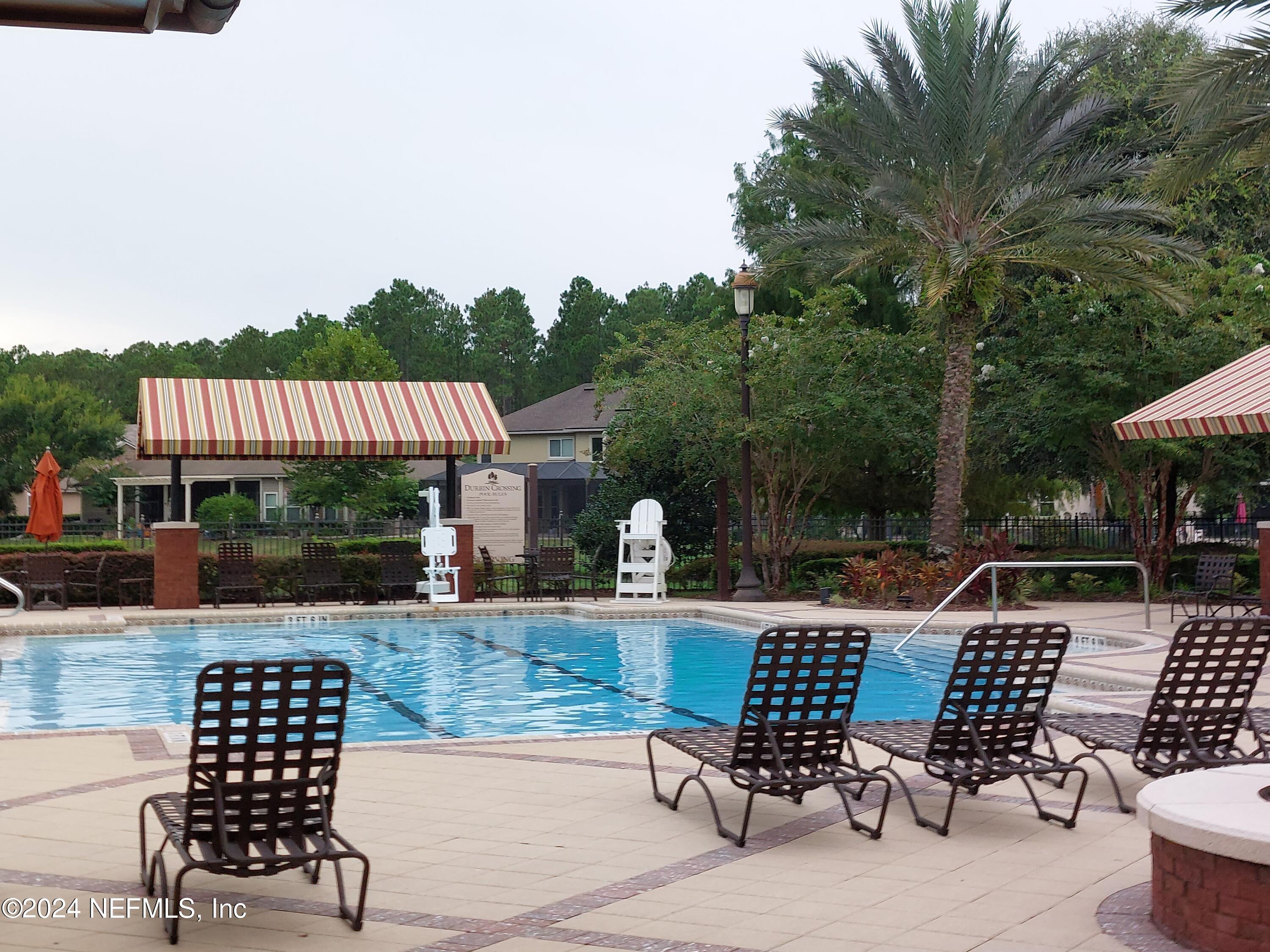 177 Richmond Drive St. Johns, FL 32259 - Photo 21 of 29 a view of a patio with a dining table and chairs with wooden floor and fence