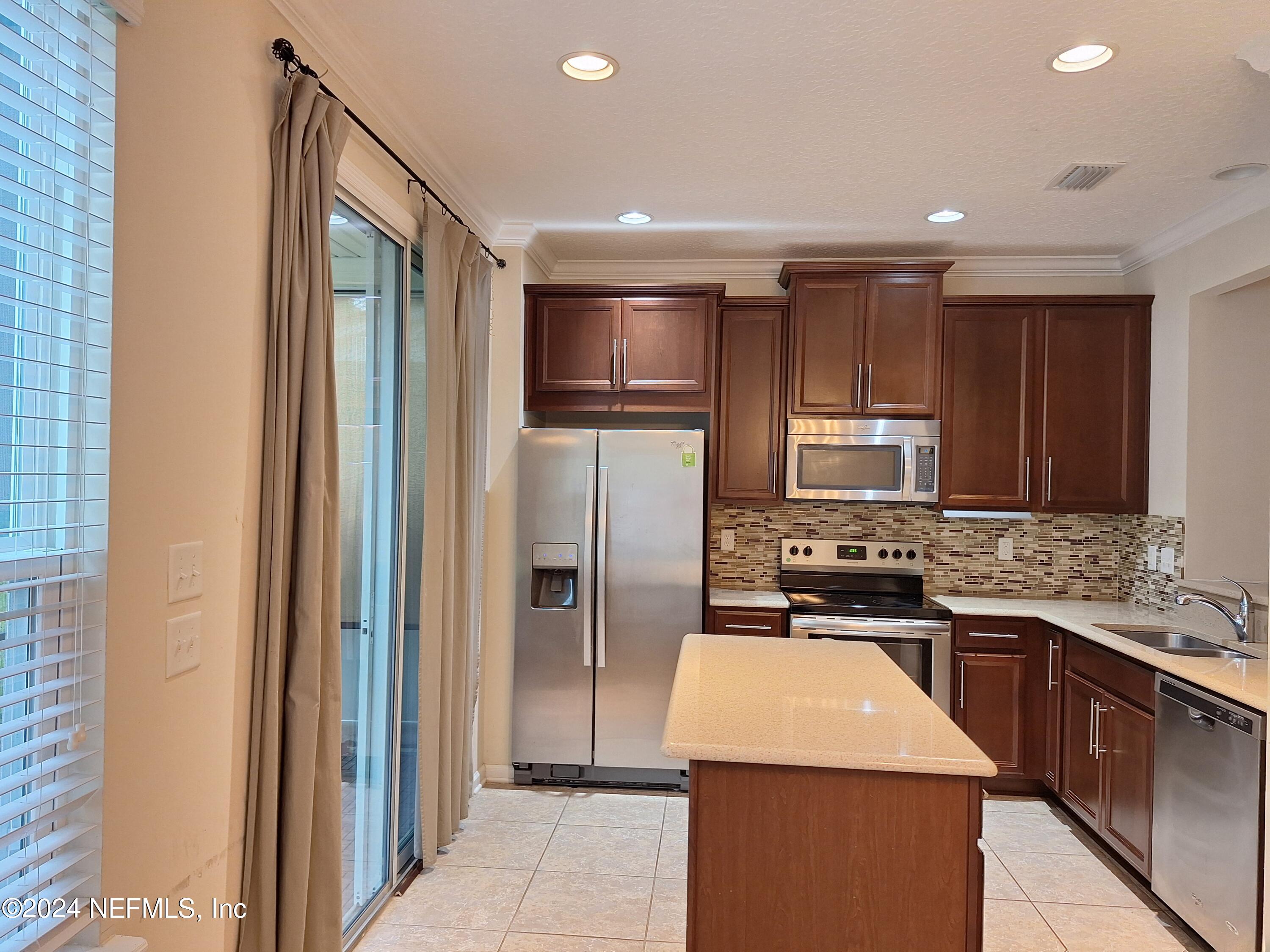 177 Richmond Drive St. Johns, FL 32259 - Photo 3 of 29 a kitchen with stainless steel appliances granite countertop a refrigerator a sink a stove a microwave and island
