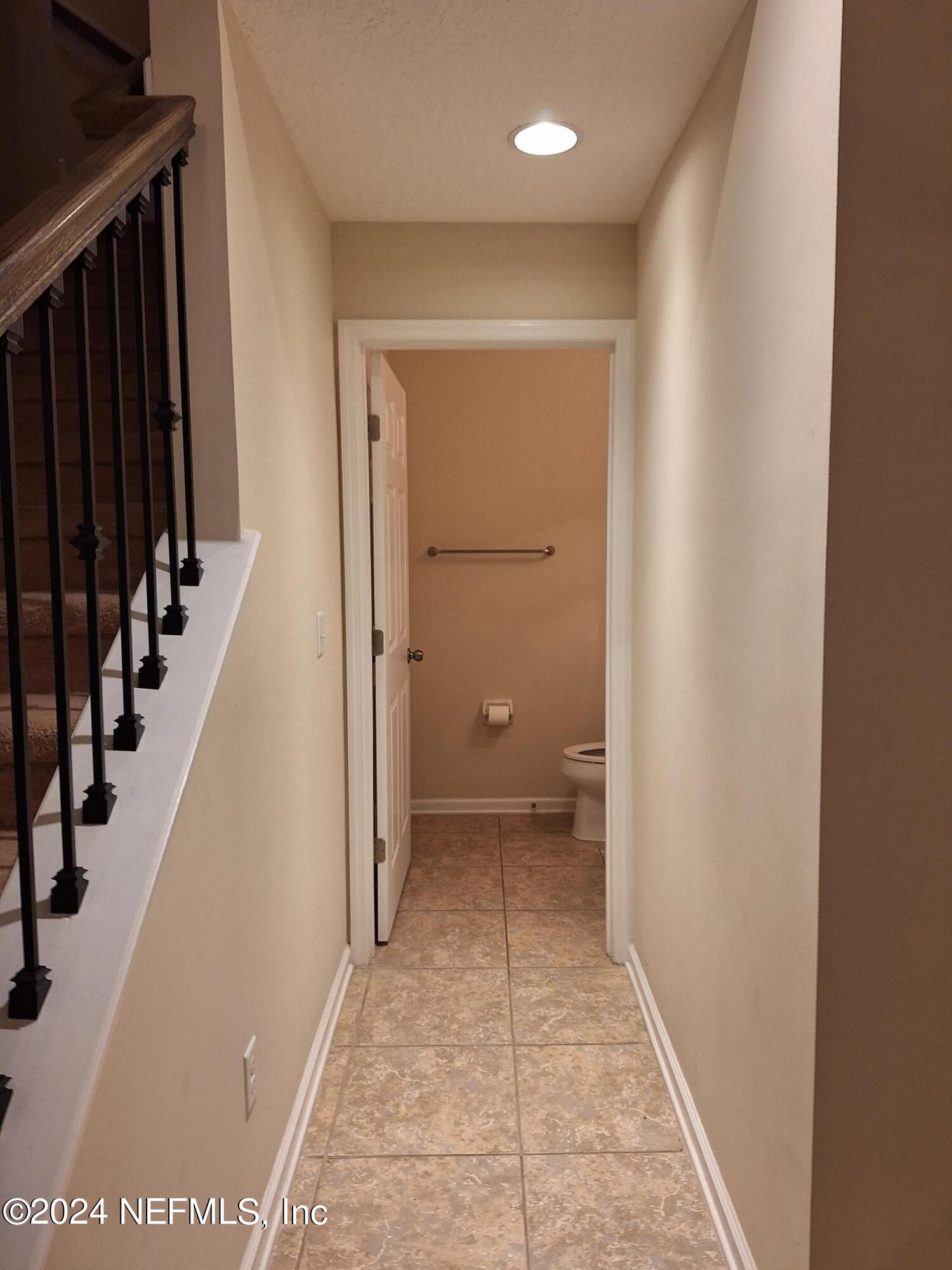 177 Richmond Drive St. Johns, FL 32259 - Photo 7 of 29 a view of a hallway with wooden floor and staircase