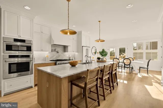 a kitchen with stainless steel appliances white cabinets and stove