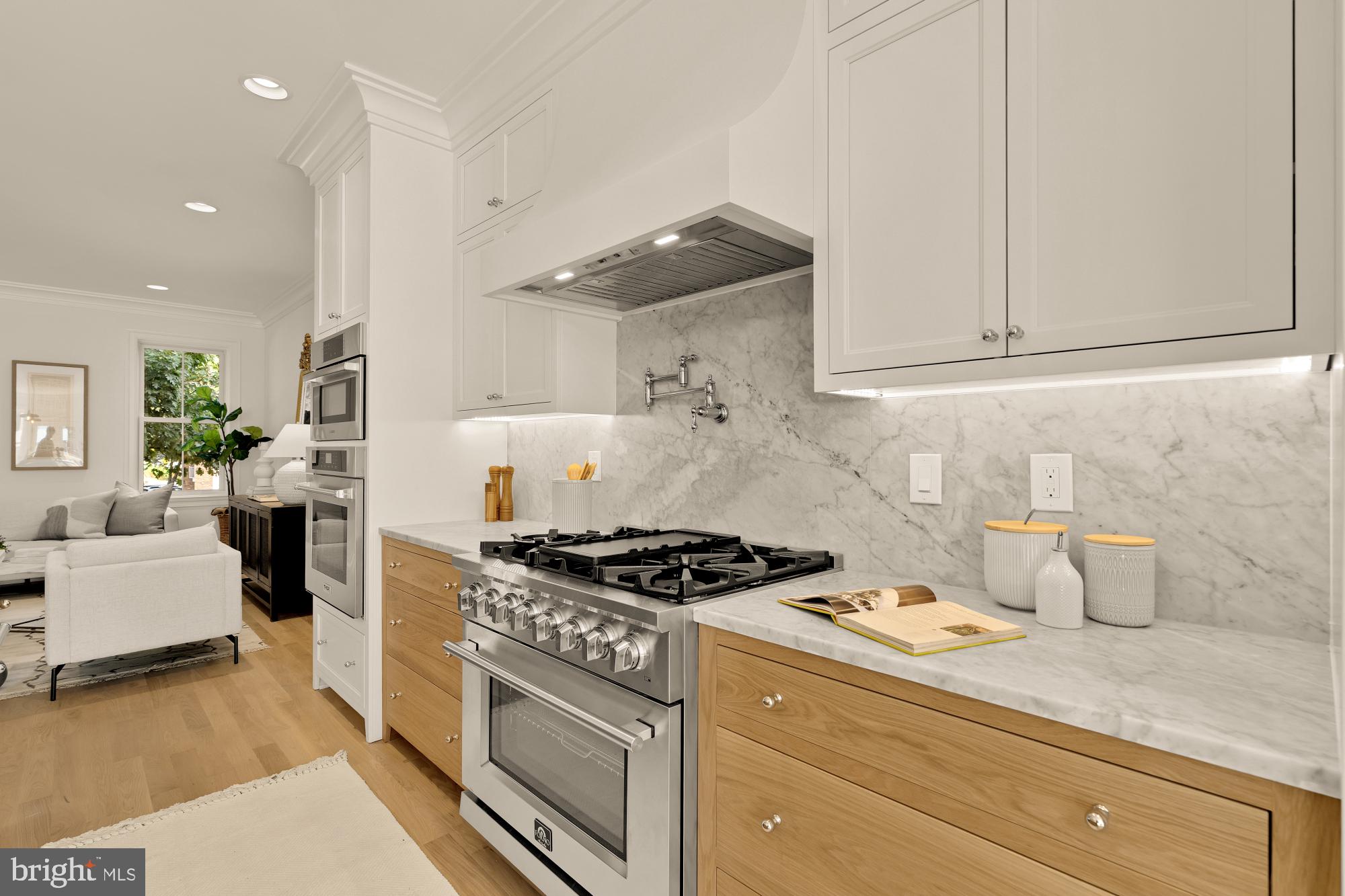 4830 8th Street Northwest Washington, DC 20011 - Photo 18 of 54 a kitchen with granite countertop a stove a sink and a white wooden cabinets