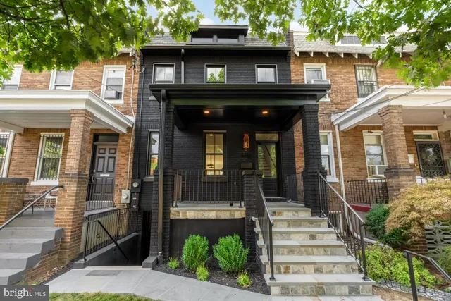 a view of an entryway with wooden floor and door