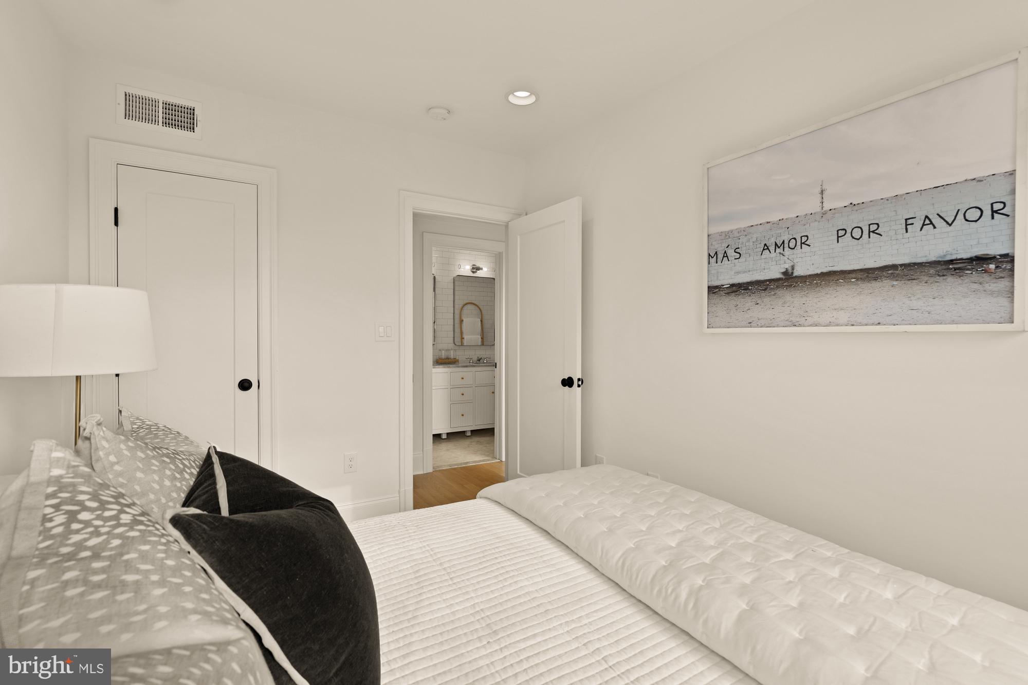 4830 8th Street Northwest Washington, DC 20011 - Photo 32 of 54 a bedroom with a bed and a lamp