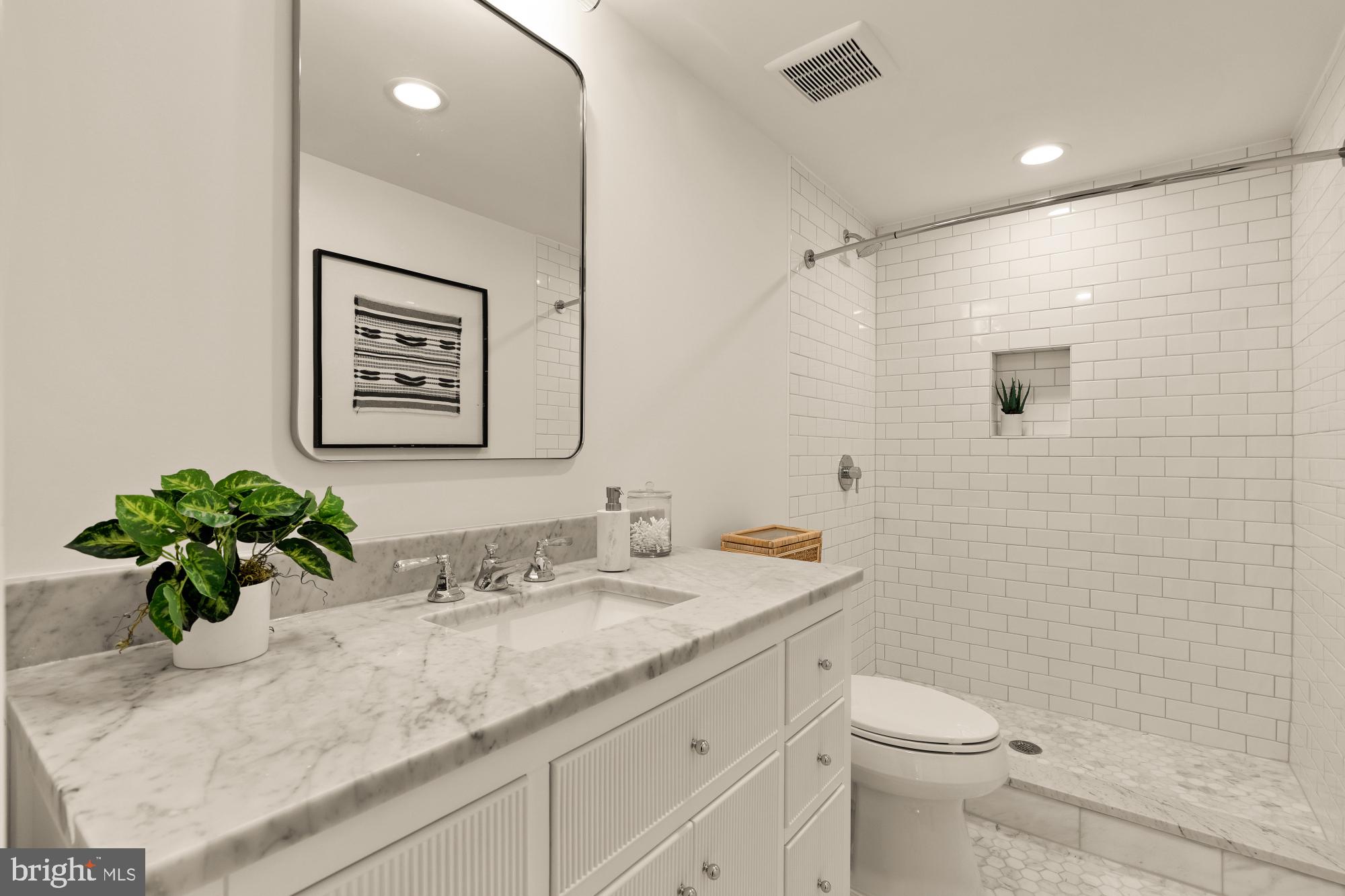 4830 8th Street Northwest Washington, DC 20011 - Photo 46 of 54 a bathroom with a granite countertop sink a toilet and mirror