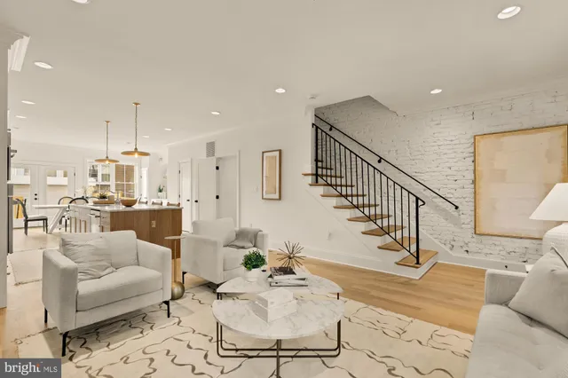 a living room with furniture and a mirror