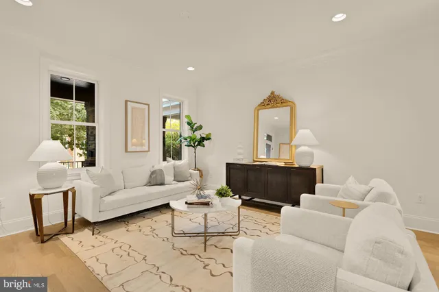 a kitchen with stainless steel appliances granite countertop a table chairs and a refrigerator
