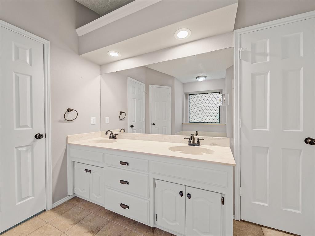 121 Northeast Brushy Mound Road Burleson, TX 76028 - Photo 29 of 35 a bathroom with double sink and mirror