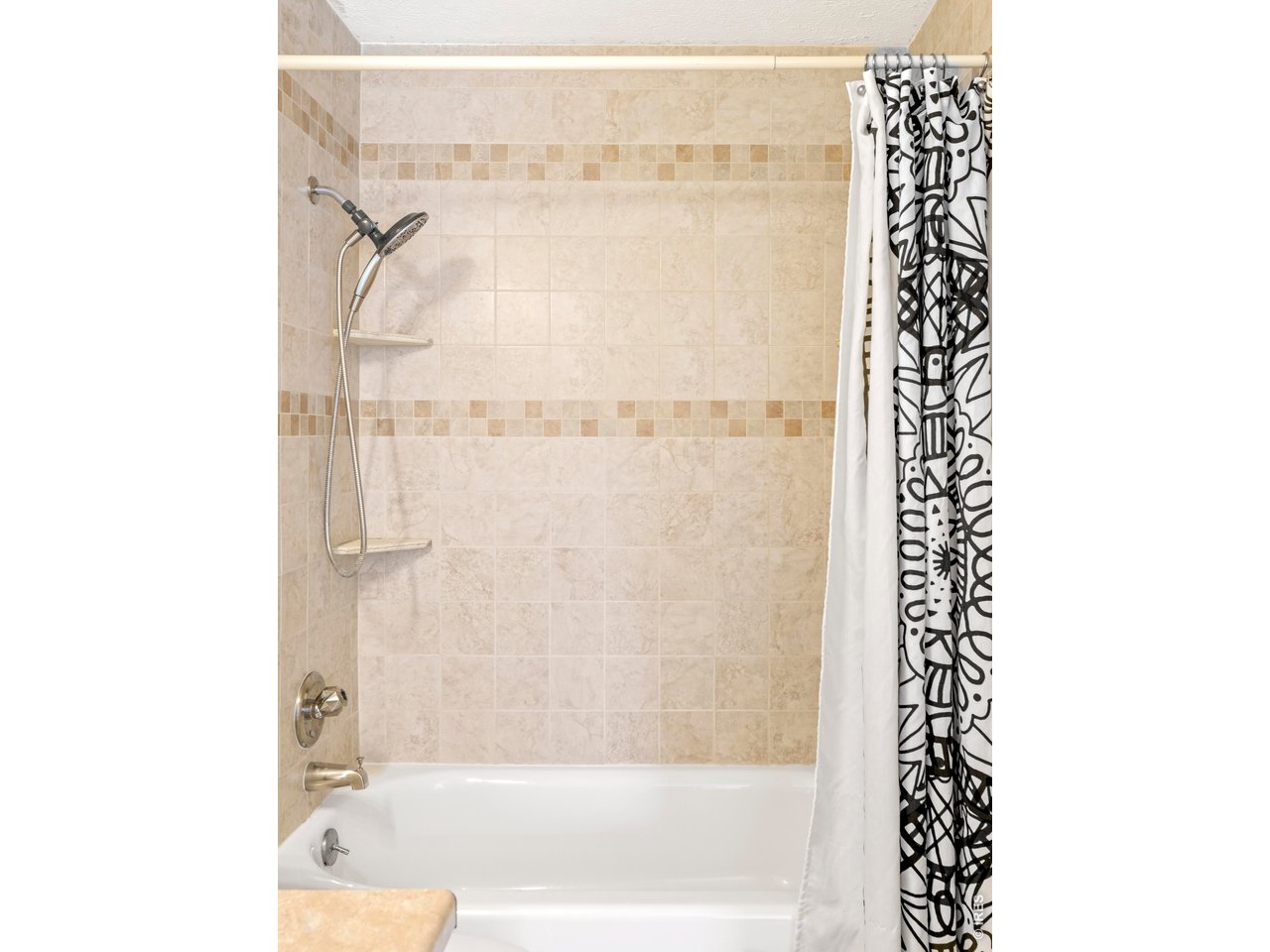 9338 Pierce Street Westminster, CO 80021 - Photo 22 of 26 a bathroom with a bathtub and a shower