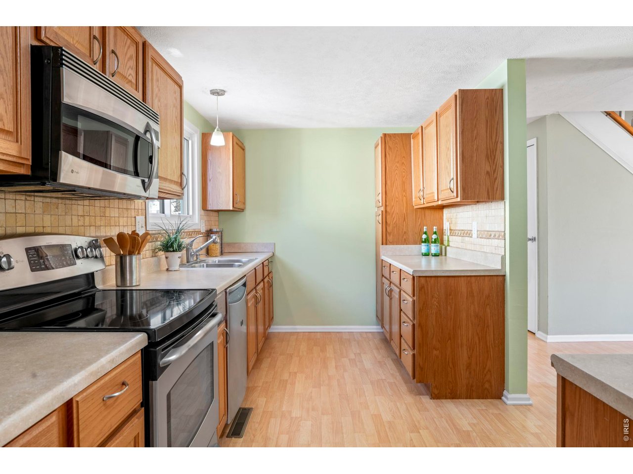 9338 Pierce Street Westminster, CO 80021 - Photo 8 of 26 a kitchen with stainless steel appliances granite countertop a sink stove and refrigerator