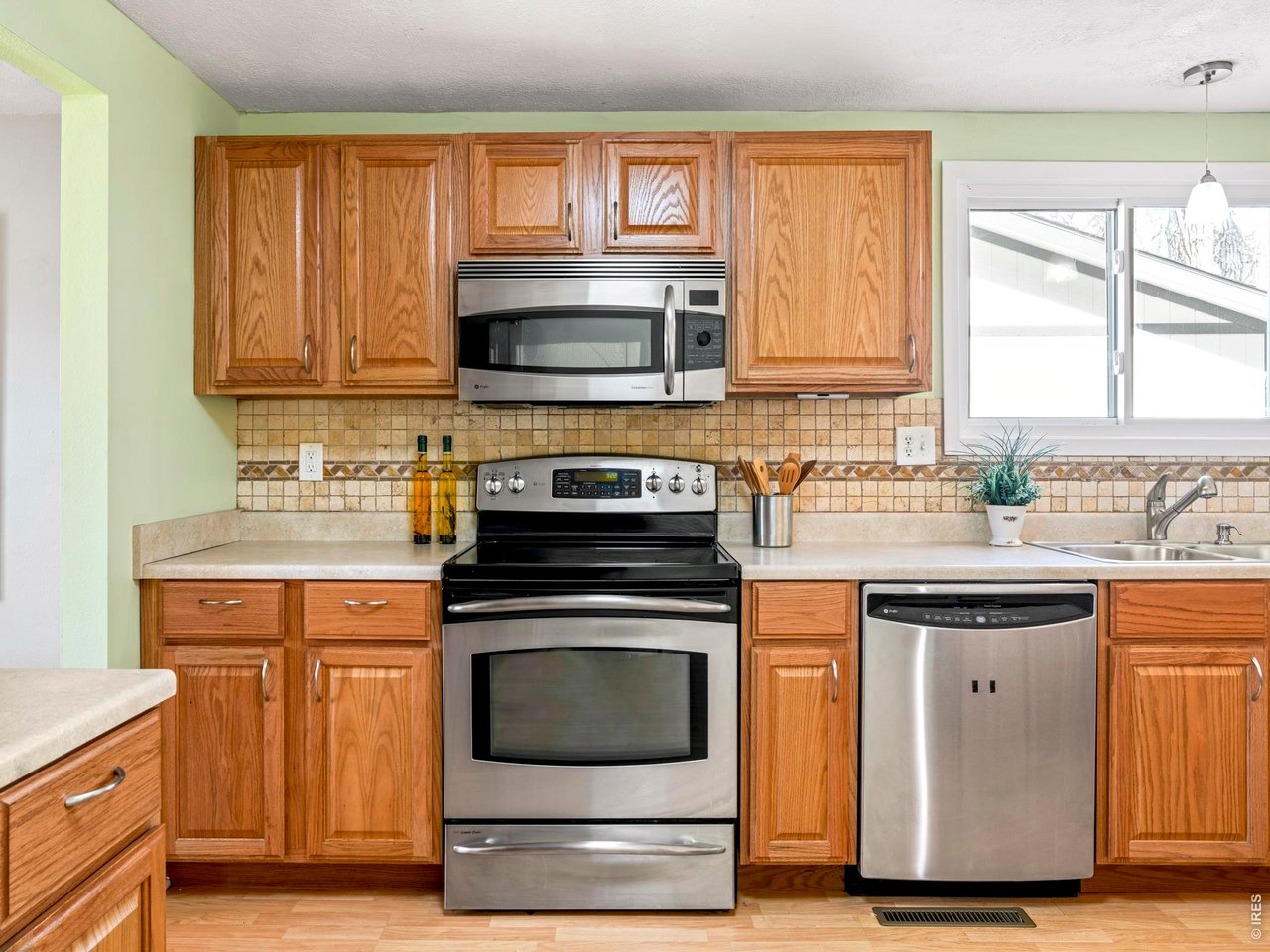 9338 Pierce Street Westminster, CO 80021 - Photo 10 of 26 a kitchen with a stove and a sink