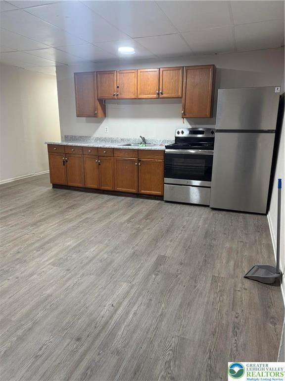 539 Atlantic Street Bethlehem, PA 18015 - Photo 3 of 12 a kitchen with wooden cabinets and a stainless steel appliances