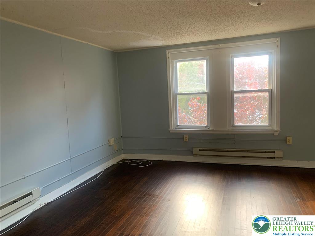 539 Atlantic Street Bethlehem, PA 18015 - Photo 8 of 12 an empty room with wooden floor and windows