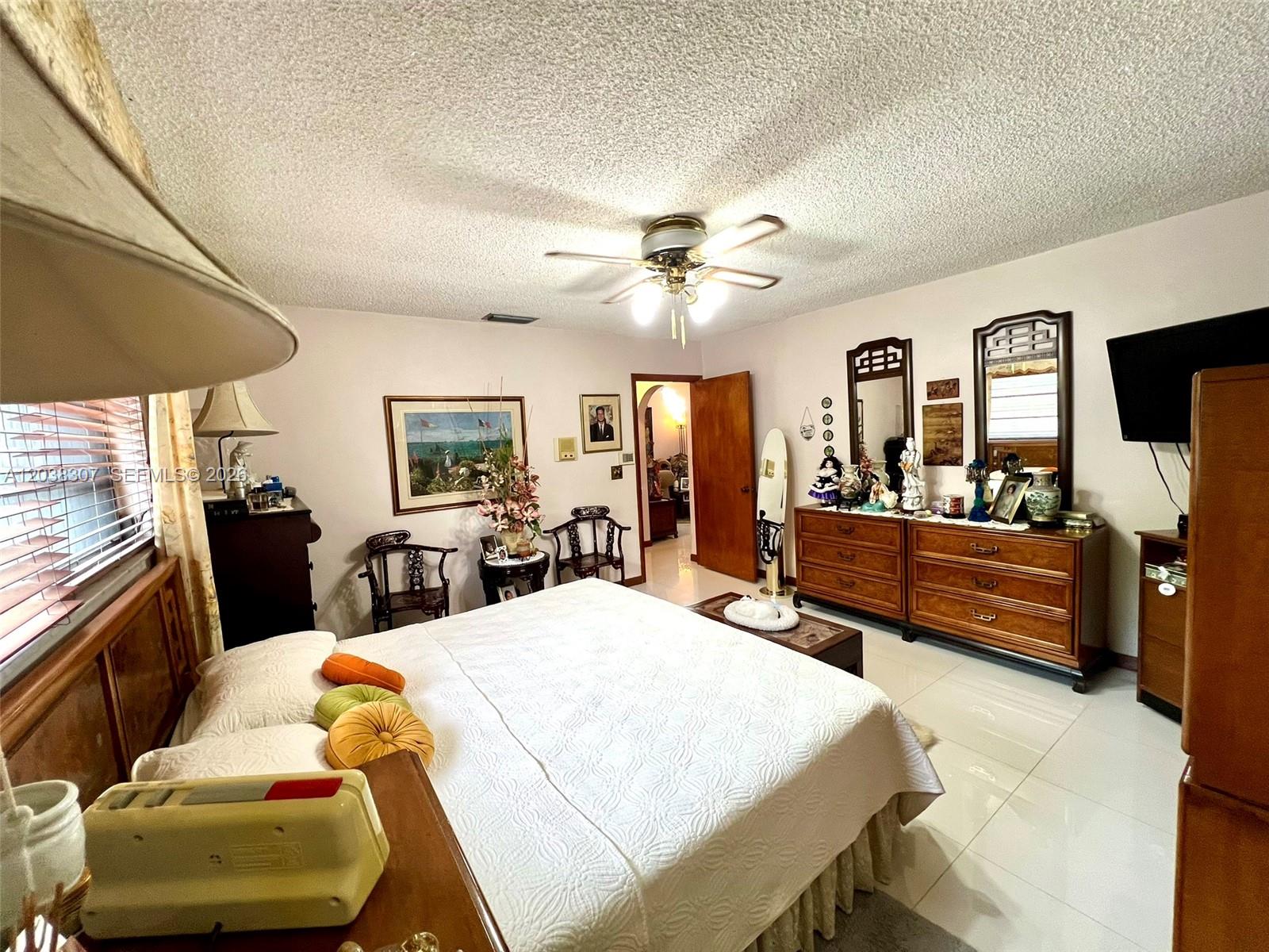 9601 Southwest 66th Street Miami, FL 33173 - Photo 25 of 62 a living room with furniture a flat screen tv and a window