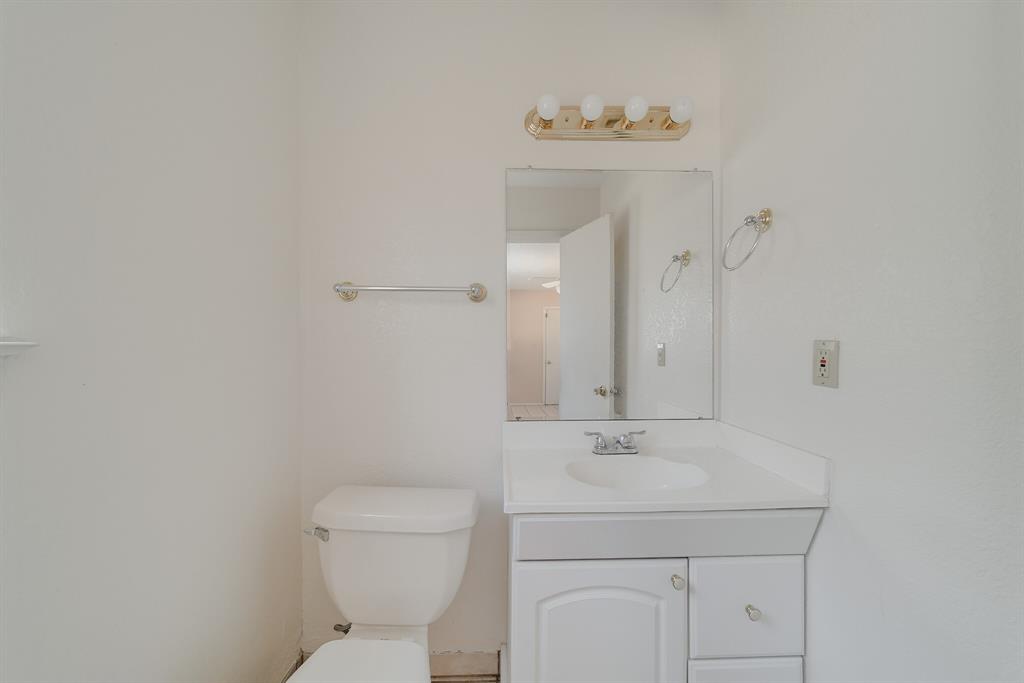 1963 East Dove Road Southlake, TX 76092 - Photo 14 of 27 a bathroom with a sink a toilet and a mirror