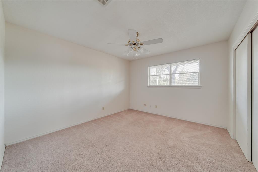 1963 East Dove Road Southlake, TX 76092 - Photo 18 of 27 an empty room with a window and a ceiling fan
