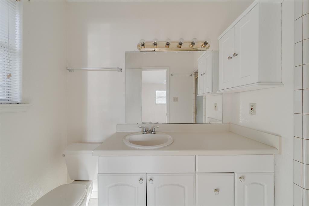 1963 East Dove Road Southlake, TX 76092 - Photo 20 of 27 a bathroom with a sink vanity and a mirror