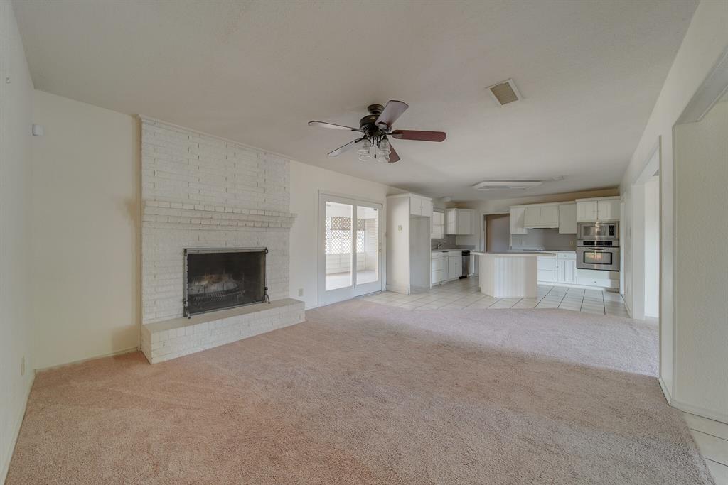 1963 East Dove Road Southlake, TX 76092 - Photo 5 of 27 a view of empty room with a fireplace and window