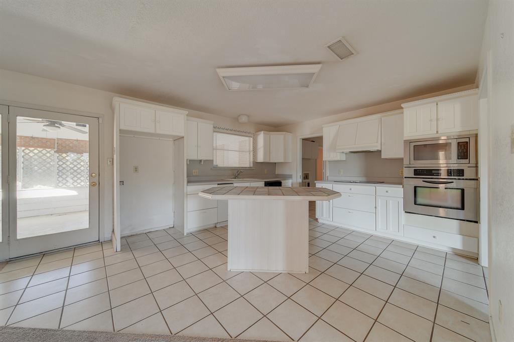 1963 East Dove Road Southlake, TX 76092 - Photo 9 of 27 a kitchen with white cabinets and white appliances