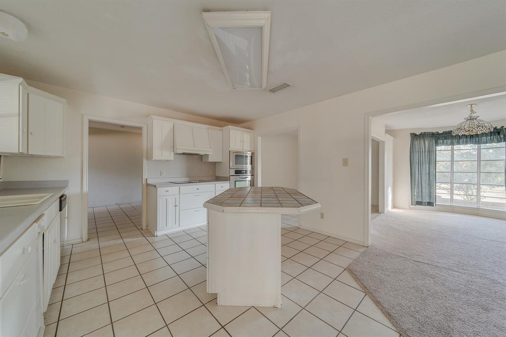 1963 East Dove Road Southlake, TX 76092 - Photo 10 of 27 a kitchen with stainless steel appliances a sink stove and cabinets