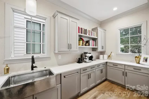 a kitchen with a sink cabinets and window
