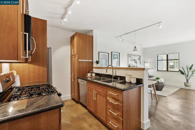a kitchen with stainless steel appliances granite countertop a stove and a refrigerator